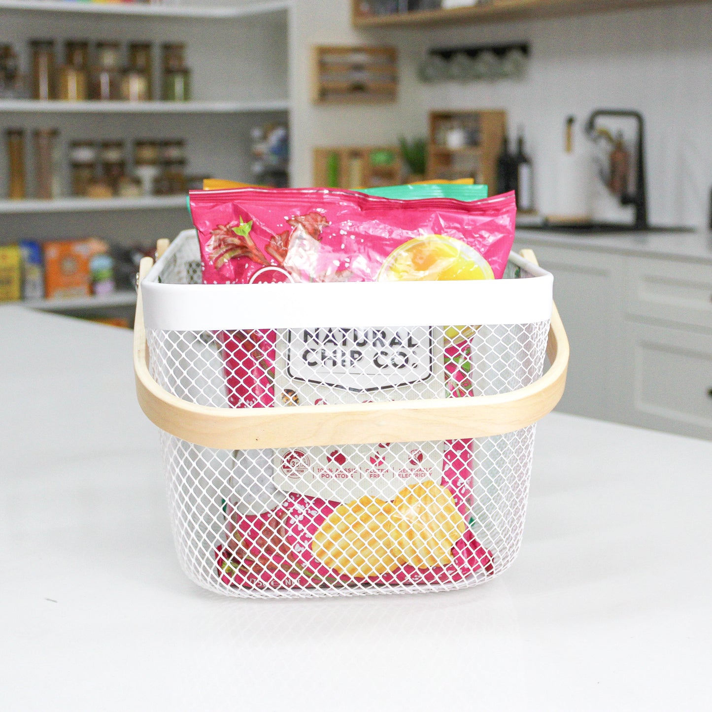 mesh metal basket with bamboo handle for home organisation, use in the kitchen, bathroom, laundry and more. 